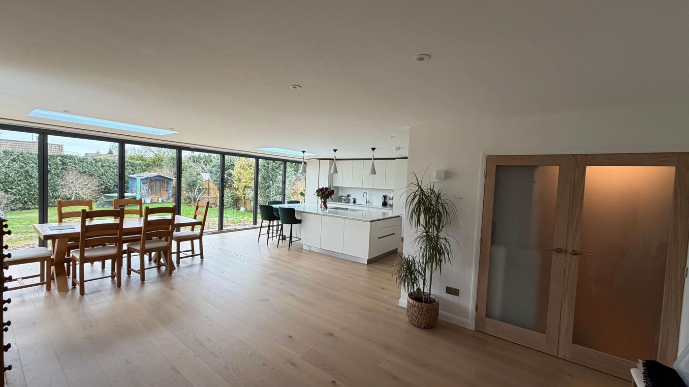 Open plan dining room in a glazed extension with garden views